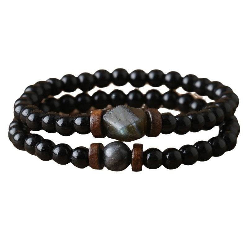 Double-layer bracelet with black beads and gray labradorite accents on a white background
