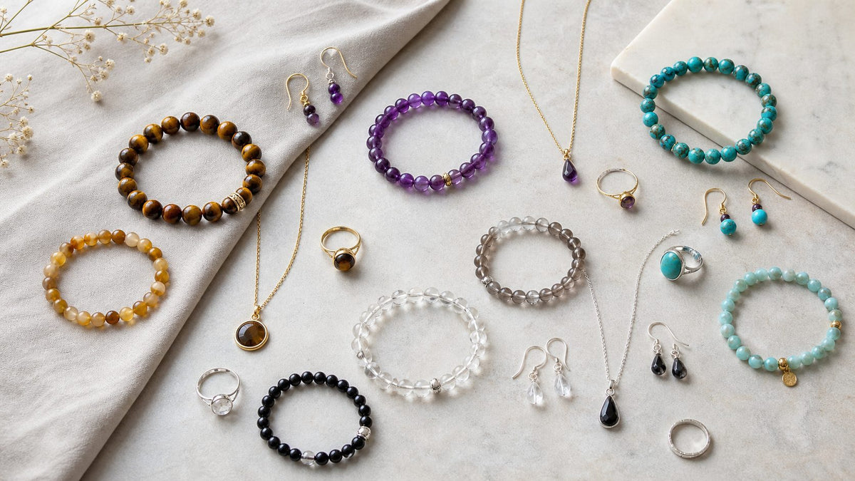 Amethyst bracelet necklace and earrings styled on a neutral surface