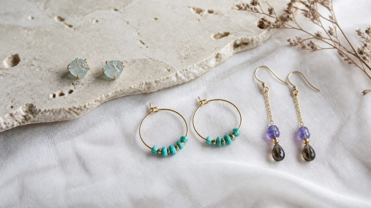 Natural stone stud, hoop, and drop earrings arranged for an everyday style guide