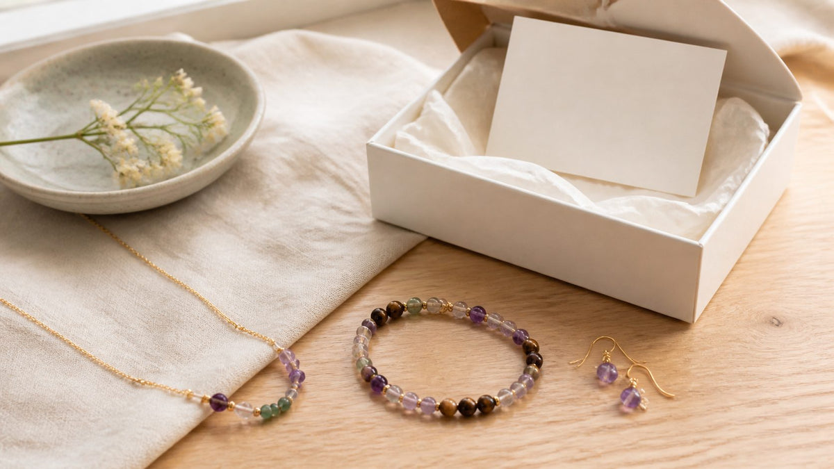 Natural stone necklace, bracelet, and earrings arranged in a refined gift setting